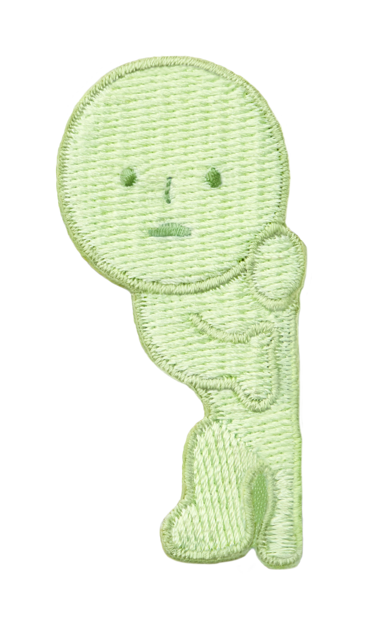 Image with transparent background shows SMISKI Embroidery Sticker "Peeking" SMISKI is a light green figure with dark green eyes, nose and mouth standing as if peeking around a doorway. 
