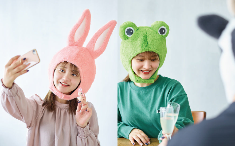 two product lifestyle images for sonny angel costume series 2 spliced down the middle; left features model wearing rabbit costume and taking a selfie with a sonny angel rabbit mini figure. right: model wearing sonny angel frog costume clinking champagne glasses with a model blurred in the foreground wearing the sonny angel cow costume.