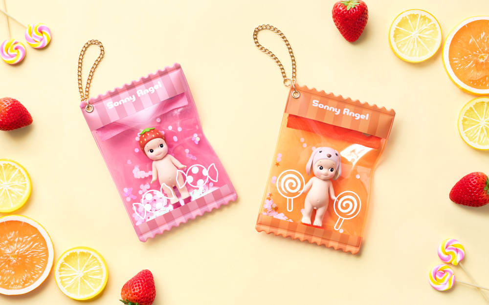 Two colorful keychain pouches with Sonny Angel figures on a yellow background with fruits and candies.