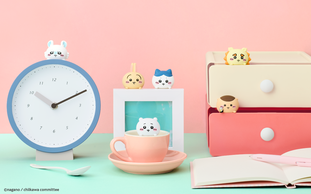 Set on a pink backdrop, Chiikawa minifigure Hippers adorn a clock, photoframe, cup and set of drawers