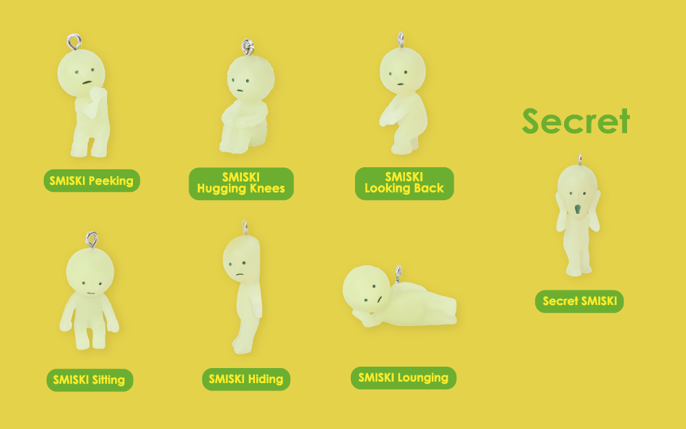 smiski strap accessory series 1 lineup against a yellow background. from left to right. row 1: smiski peekng, smiski hugging knees, smiski looking back, SECRET SMISKI. row2: smiski sitting, smiski hiding, smiski lounging.