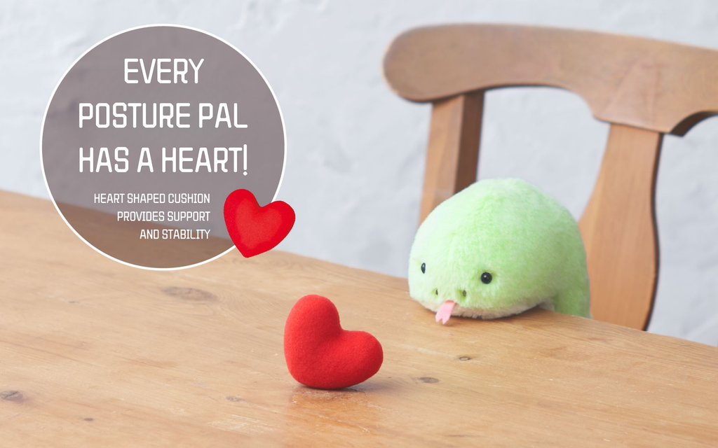 banner image for posture pal year of the snake green featuring posture pal sitting at a desk. text in a bubble on the left reads EVERY POSTURE PAL HAS A HEART! HEART SHAPED CUSHION PROVIDES SUPPORT AND STABILITY