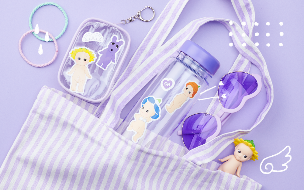 product lifestyle image of the sonny angel sticker pack volume 2 stickers featuring die-cut sonny angel stickers cut out and placed on various personal items. stickers are from the flower series and are placed on a vinyl pouch and plastic water bottle. the overall theme of the image is PURPLE and there are small white doodle accents across the image. there is a sunflower sonny angel mini figure in the lower righthand corner