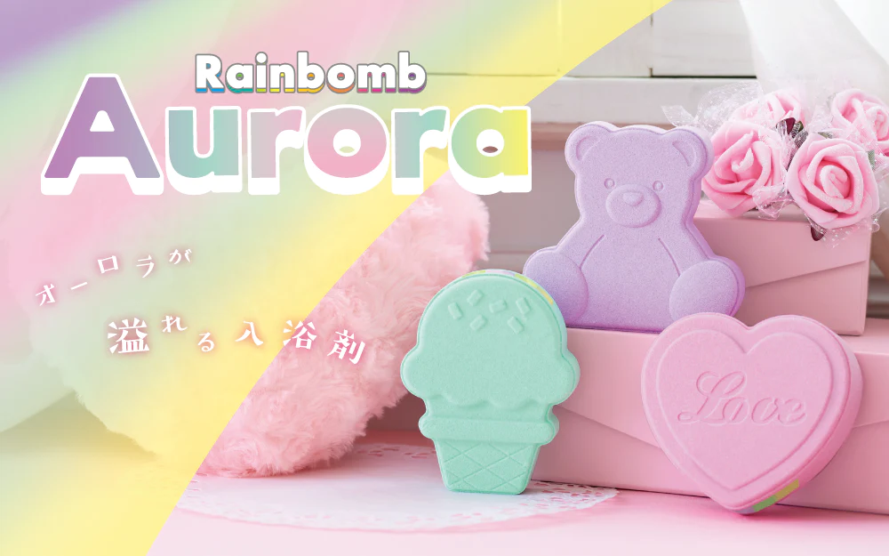 Three Aurora-themed bath bombs named Heart, Ice Cream, and Bear, in pastel green, purple, and pink colors, designed to mimic the look of the Northern Lights when melted.