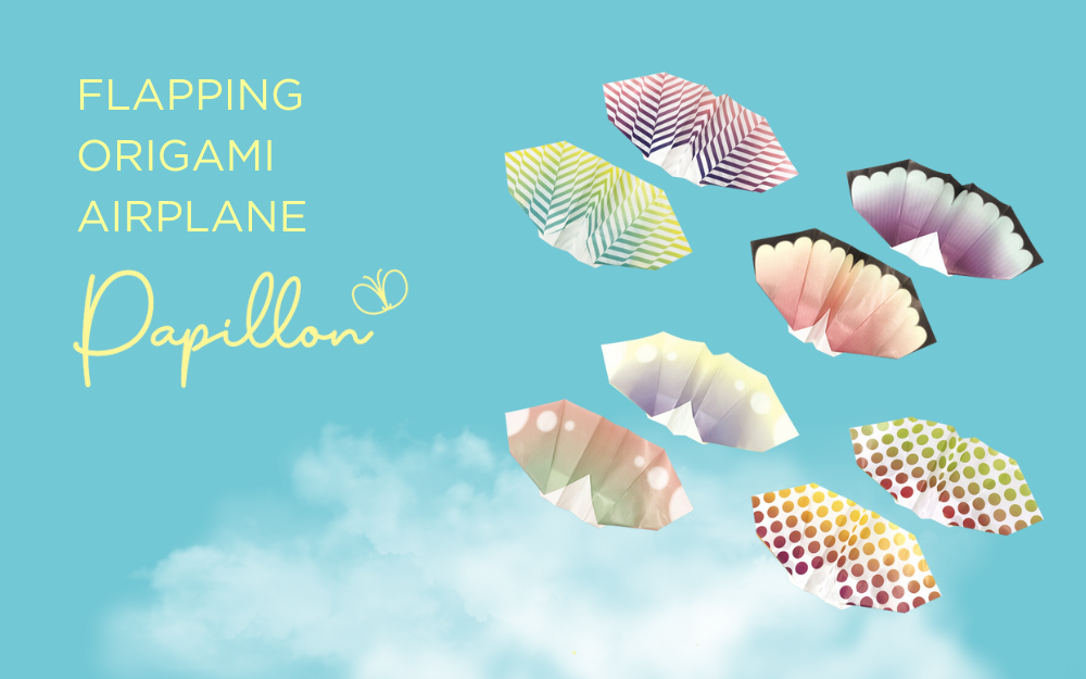 A collection of colorful origami airplanes with butterfly wing designs, displayed against a blue background with cloud illustrations.