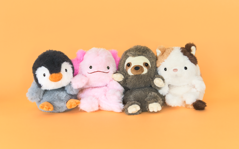 Posture Pal Wrist Cushion product lineup; from left to right the Penguin, Axolotl, Sloth and Calico Cat