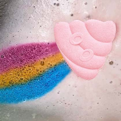 product closeup of rainbomb emoji pink peach in water surrounded by pink foam and a pink, yellow, and blue trail