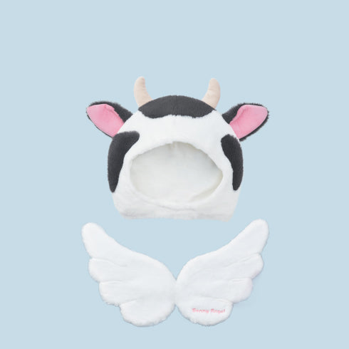 closeup product image of the sonny angel costume series 2 refined cow costume headdress from the front and wings from the back on a blue background. 