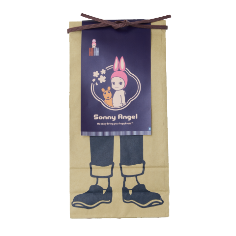 Image on transparent background shows "Maekake" apron as a poster image set atop an illustration of legs and feet. The apron design depicts Rabbit Sonny Angel beside Robby encircled with concentric circles and cherry blossoms, and text: "Sonny Angel" "He may bring you happiness?!". Rabbit Sonny Angel minifigure is shown in a small red and white pocket. 