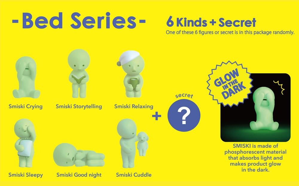 smiski bed series illustrated line up with all figures text bed series six kinds plus secret one of these six figures or secret is in this package randomly smiski crying smiski storytelling smiski relaxing smiski sleepy, smiski goodnight smiski cuddle secret glow in the dark smiski is made of phosphorescent material that absorbs light and makes product glow in the dark. image of smiski crying glowing green against a dark background